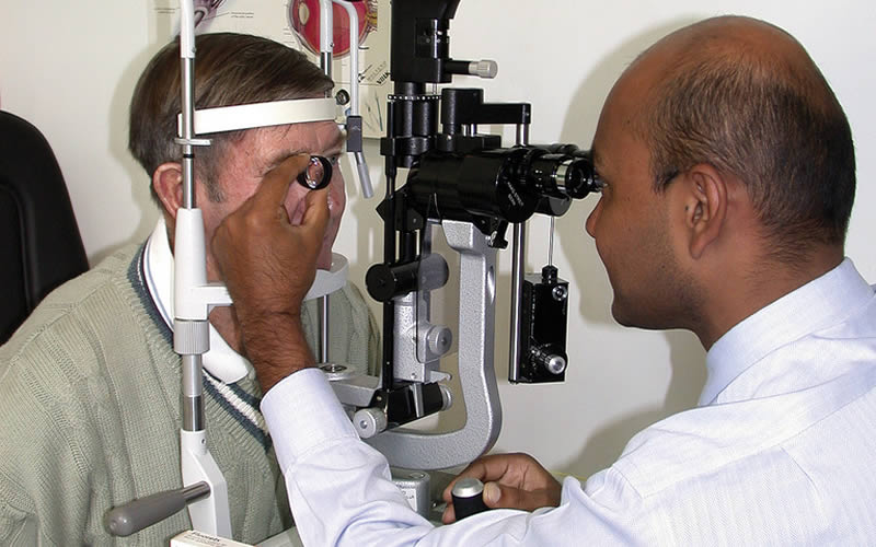 An ophthalmologist examining the posterior segment of the eye. UK. © Richard Leung