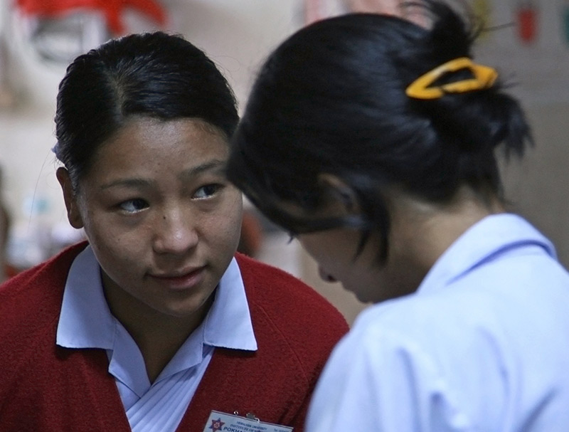 Two nurses in conversation with one another