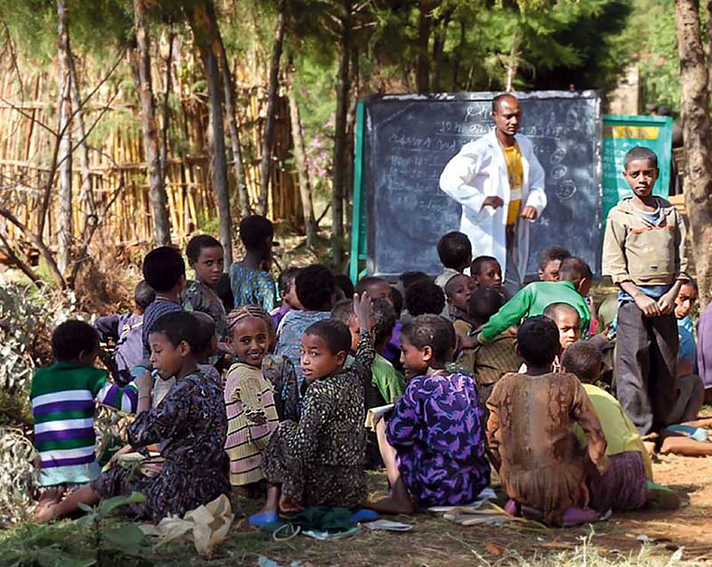School children at a class held outside